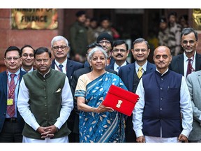 Nirmala Sitharaman, India's finance minister, center, and other members of the finance ministry leave the ministry to present the budget at the parliament in New Delhi, India, on Thursday, Feb. 1, 2024. Prime Minister Narendra Modi will likely use India's last budget before the elections to woo voters with new spending measures, while avoiding a fiscal deficit increase.