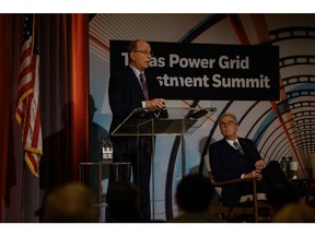 Larry Fink delivers opening remarks beside Dan Patrick at the summit in Houston on Tuesday. Photographer: Callaghan O'Hare/Bloomberg