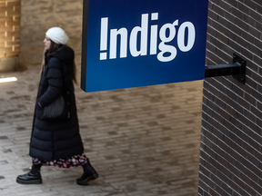 A shopper walks by an Indigo Books & Music store