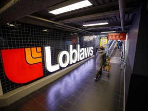 A shopper enters a Loblaw grocery store in Toronto.