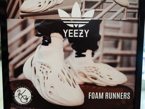 FILE - A sign advertises Yeezy shoes made by Adidas at Kickclusive, a sneaker resale store, in Paramus, N.J., Oct. 25, 2022. Shoe and sports clothing maker Adidas said Monday, Feb. 26, 2024, it had started a third sale of the Yeezy sneakers it was left with after severing ties with Ye, the rapper formerly known as Kanye West.