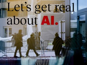 People reflected in a window of a hotel at the Davos Promenade with a slogan about AI alongside the World Economic Forum in Davos, Switzerland, Jan. 15, 2024.