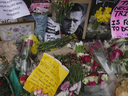 Flowers and portraits are left opposite the Russian embassy in London on Monday, Feb. 19, 2024, to commemorate the death of jailed Russian opposition politician Alexei Navalny in an Arctic Circle “corrective camp.”