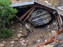 A car lies under the wreckage after a house and garage were destroyed by a landslide as a historic atmospheric river storm inundated the Hollywood Hills area of Los Angeles, on Feb. 6, 2024.