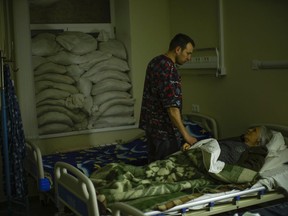 FILE - Doctor Ivan Mozhaiev attends to a patient during morning rounds at Pokrovsk hospital in Pokrovsk, eastern Ukraine, on May 22, 2022. Fidelity Charitable, the nation's largest grantmaker, distributed a record-setting $11.8 billion to nonprofits in 2024, up more than 5% from the previous year at a time when generally donations are dropping. Doctors Without Borders USA and St. Jude Children's Research Hospital were the most popular charities again, as they were in 2022.