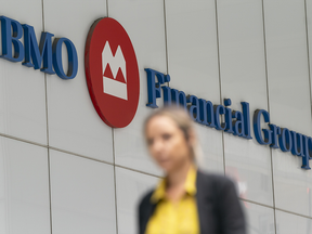 Young woman walks in front of BMO signage