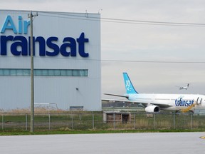 An Air Transat plane is seen as an Air Canada plane lands at Pierre Elliott Trudeau International Airport in Montreal on Thursday, May 16, 2019.&ampnbsp;The union representing 2,100 Air Transat flight attendants says they have rejected a tentative agreement for the second time in a month.