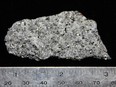 A flake graphite ore sample. Once Nouveau starts production, it will supply GM with graphite for six years and Panasonic for seven.