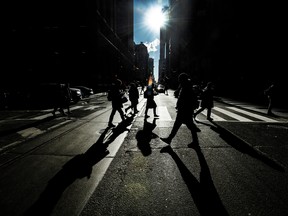 Pedestrians in Toronto's financial district. There are fewer remote work job listings for high-wage earners.