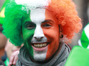 A reveller with his face painted the colours of the Irish flag attends St Patrick's Day festivities in Dublin