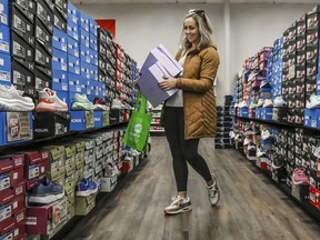 FILE - Ashley Crafton looks at tennis shoes at Shoe Stop in Wesleyan Park Plaza on Nov. 25, 2023, in Owensboro, Ky. About 40% of small business owners think 2024 will be a "make or break" year for their business, according to a survey by messaging service Slack.