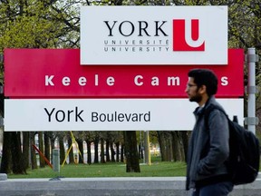 A student walks past a sign at the Keele campus of York University in Toronto.0