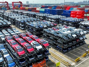 BYD electric cars waiting to be loaded on a ship are stacked at the international container terminal of Taicang Port at Suzhou Port, in China's eastern Jiangsu Province.