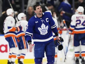 Toronto Maple Leafs' John Tavares (91) skates off the ice as the New York Islanders celebrate their win in NHL hockey action in Toronto on Feb. 5.