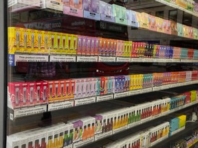 A selection of colourful disposable vapes on display for sale in a souvenir shop in London.