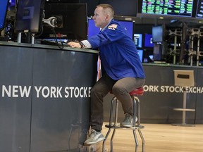 FILE - Traders work on the floor at the New York Stock Exchange in New York, Friday, June 2, 2023.