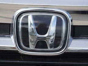 FILE - The Honda company logo is shown outside a Honda dealership Sunday, Sept. 12, 2021, in Highlands Ranch, Colo. Honda is recalling more than three quarters of a million vehicles in the U.S. because a faulty sensor may cause the front passenger air bags to inflate when they're not supposed to.