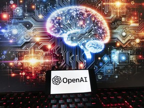 FILE - The OpenAI logo is displayed on a cell phone with an image on a computer monitor generated by ChatGPT's Dall-E text-to-image model, Friday, Dec. 8, 2023, in Boston. The maker of ChatGPT is now diving into the world of AI-generated video. Meet Sora -- OpenAI's new text-to-video generator. The tool, which the San Francisco-based company unveiled on Thursday, Feb. 16, 2024 uses generative artificial intelligence to instantly create short videos based on written commands.