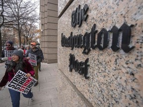 FILE - Employees of the Washington Post picket outside the company's offices in downtown Washington, Thursday, Dec. 7, 2023, amid a one-day strike over labor issues. The Washington Post is completing buyouts to more than 200 staffers.