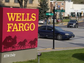 Motorists drive past a sign outside a branch of Wells Fargo bank, Wednesday, Sept. 20, 2023, in Deadwood, S.D. The Biden Administration is easing its restrictions on banking giant Wells Fargo, saying the bank has sufficiently fixed its toxic culture after years of scandals. The news sent Wells Fargo's stock up sharply in afternoon trading as investors speculated that the bank, which has been kept under a tight leash by regulators for years, may be able to start growing again.