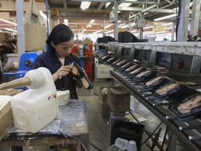 FILE - A woman works in a shoe maquiladora or factory in Leon, Mexico, Feb. 7, 2023. For the first time in more than two decades, Mexico last year overtook China as America's top supplier of goods -- a shift that reflects political tensions between Washington and Beijing and U.S. efforts to import from countries that are friendlier and closer to home.