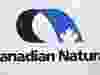 Canadian Natural Resources Ltd. raised its quarterly dividend as it reported a fourth-quarter profit of $2.63 billion, up from $1.52 billion a year earlier. The Canadian Natural Resources logo is shown at the company's annual meeting in Calgary, Thursday, May 4, 2017.