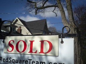 A real estate sold sign is shown in a Toronto west end neighbourhood May 16, 2020.