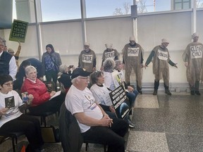 Protesters pack a meeting of the Ohio Oil and Gas Land Management Commission in Columbus, Ohio on Monday, Feb. 26, 2024. The commission awarded bids to frack for oil and under public land Monday, including state parks and designated wildlife areas, to several oil and gas companies.