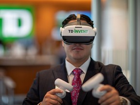 A TD Bank staffer tries out a virtual reality training aid at a branch in Etobicoke, Ont.