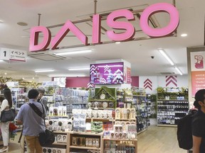 Shoppers visit a Daiso shop as the shop opened to the media in Tokyo, on April 13, 2022. Hirotake Yano, who founded the retail chain Daiso known for its 100-yen shops, Japan's equivalent of the dollar store, has died. He was 80.(Kyodo News via AP)