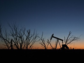 The silhouette of a pumpjack is seen at dusk in the Permian Basin near Midland, Texas.