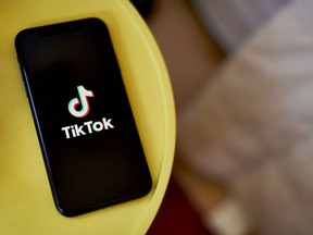 The TikTok logo on a smartphone.