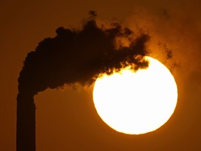 FILE - Emissions rise from the smokestacks at the Jeffrey Energy Center coal power plant as the suns sets Sept. 18, 2021, near Emmett, Kan. The Biden administration is setting tougher standards for deadly soot pollution, saying that reducing fine particle matter from tailpipes, smokestacks and other industrial sources could prevent thousands of premature deaths a year.