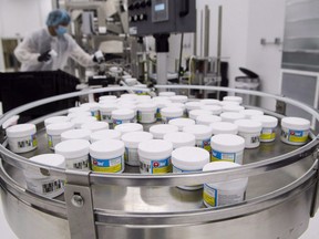 CannTrust employees work with cannabis products at their packaging and extraction facility in Vaughan, Ont., on Wednesday, Dec. 19, 2018. More than five years after cannabis was legalized in Canada, the government has released its final report of the legislative review of the Cannabis Act.