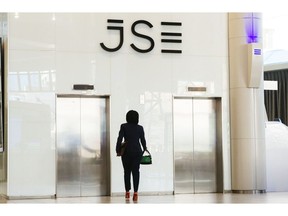 A logo stands above the elevators in the reception area of the Johannesburg Stock Exchange (JSE) in the Sandton district of Johannesburg, South Africa, on Monday, Sept. 3, 2018. The emerging-market sell-off may have already battered South Africa's rand, but it could get worse as traders fret about a push for land reform that may have far-reaching economic consequences and is catching the attention of world leaders.