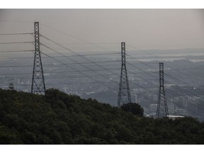 Electricty  lines part of the Centrais Eletricas Brasileiras SA (Eletrobras) descend from Tijuca forest towards  Rio de Janeiro, Brazil, on Friday, May 21, 2021. Brazils lower house approved the main text of a bill that paves the way for the privatization of state utility Eletrobras.