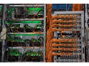 Power cables and ethernet cables connected to cryptocurrency mining rigs.