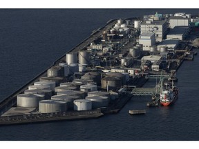 Oil storage tanks in Osaka Bay in Osaka, Japan, on Monday, Feb. 12, 2024. Japan is scheduled to release its fourth-quarter gross domestic product (GDP) figures on Feb. 15. Photographer: Buddhika Weerasinghe/Bloomberg