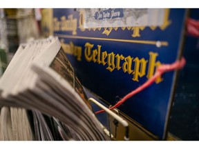 Daily Telegraph newspaper branding at a newsstand in London.