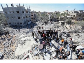 People inspect damage following Israeli air strikes in Rafah, Gaza, on March 20. Photographer: Ahmad Hasaballah/Getty Images