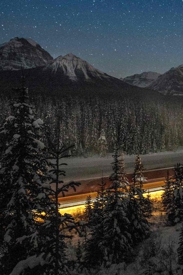 A cargo train passes through the famous Morant's Curve on the Bow River at Banff National park near Lake Louise.