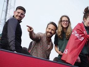FILE - Wrexham co-owner Ryan Reynolds, center, celebrates with members of the Wrexham FC soccer team the promotion to the Football League in Wrexham, Wales, on May 2, 2023. Ryan Reynolds' Wrexham is headed back to the United States. The low-level Welsh club which has gained global recognition after being bought by Hollywood duo Reynolds and Rob McElhenney, will play English Premier League side Chelsea on July 24.
