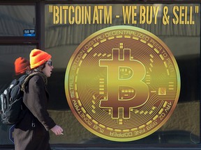 A sign advertises a Bitcoin ATM at a shop in Halifax. The cryptocurrency gains this year have topped 70 per cent.