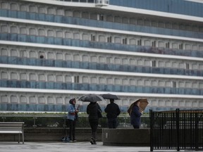 Cruises are surging back to popularity among Canadians this spring break, as more travellers look to try a mode of tourism they may have avoided since the COVID-19 pandemic. People use umbrellas to shield themselves from the rain as the Princess Cruises cruise ship Majestic Princess is seen docked at port, in Vancouver, B.C., Monday, Sept. 25, 2023.