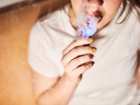 A young person vapes.