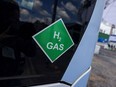 A chemical symbol on a hydrogen-powered bus at a green hydrogen refinery in Germany.