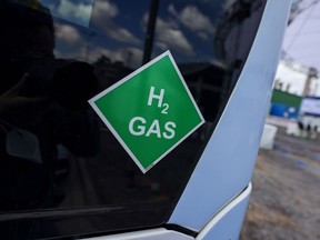 A chemical symbol on a hydrogen-powered bus at a green hydrogen refinery in Germany.