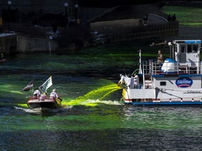 FILE - Members of the Plumbers Union Local 130 dye the Chicago River green, Saturday, March 12, 2022, ahead of St. Patrick's Day. America's largest St. Patrick's Day parades are being held Saturday, March 16, 2024. While the St. Patrick's Day holiday is March 17, it's celebrated early when it lands on a Sunday.