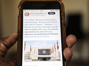 A view of a local scrolling on the X app formerly known as Twitter on a smartphone, in Kampala, Uganda Monday, March 4, 2024. An online protest campaign exposing corruption has rattled government officials and others in Uganda, where street protests are practically outlawed. The campaign, which relies on leaks of official documents, has been presented on the social media platform X as an "exhibition" -- in a sequence of postings -- about controversial issues, from failing hospitals to potholes in the streets of Kampala, the Ugandan capital.