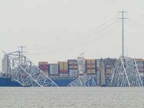 A container ship rests against the wreckage of the Francis Scott Key Bridge on Thursday, March 28, 2024, in Baltimore, Md. The ship rammed into the major bridge in Baltimore early Tuesday, causing it to collapse in a matter of seconds and creating a terrifying scene as several vehicles plunged into the chilly river below.